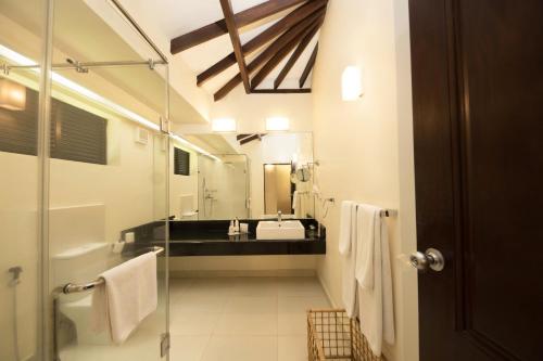 a bathroom with a sink and a mirror at Club Hotel Dolphin in Negombo