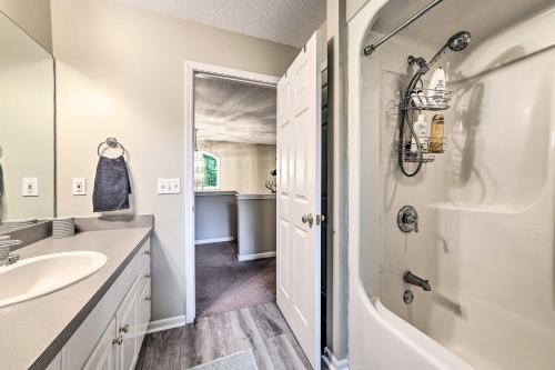 a bathroom with a sink and a shower and a tub at Bellaire Ski Escape about 1 Mile to Schuss Mountain! in Bellaire