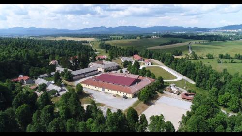 an aerial view of a building in a field with trees at Prestranek Castle Estate in Postojna