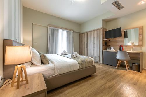 a bedroom with a bed and a desk in a room at Hotel @Syngrou Fix in Athens