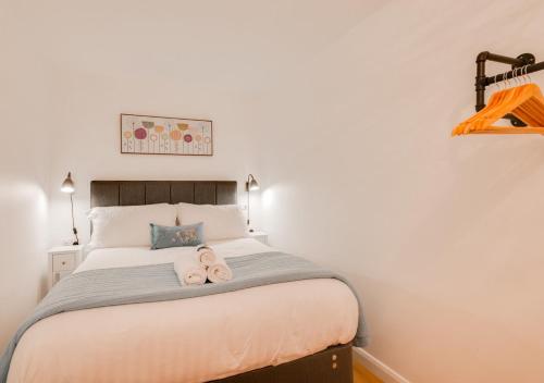 a bedroom with a bed with two stuffed animals on it at Woodridge Court in Newton