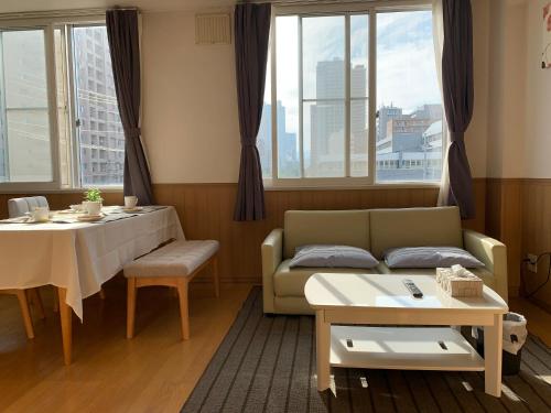 a living room with a couch and a table at NK　apartment　 in Sapporo