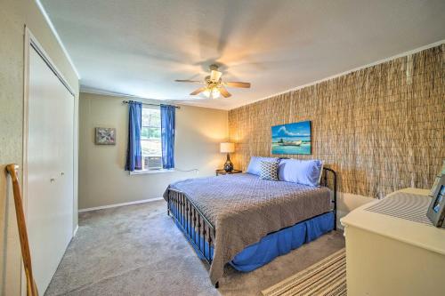 a bedroom with a bed and a ceiling fan at Mountainburg Apt Less Than 5 Mi to Lake Fort Smith! in Chester
