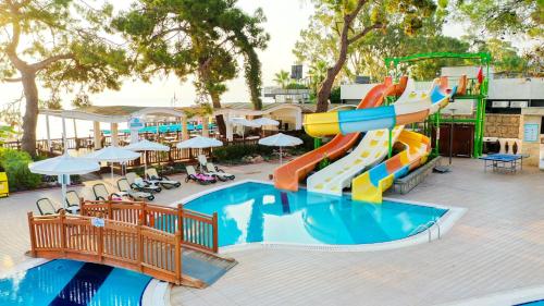 a water slide in a pool at a resort at Crystal Aura Beach Resort & Spa - Ultimate All Inclusive in Kemer