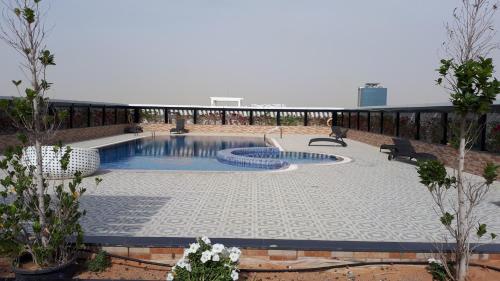 a swimming pool on the roof of a building at DUBAI - Glitz 3 Residences - MAJESTIC Luxe Holiday Home - 2BR - Sleep 4 - FOR FAMILIES & COUPLES STAYS ONLY in Dubai