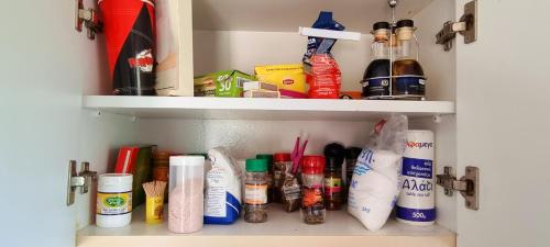 a cupboard filled with lots of cleaning products at Astrofegia Apartments Near The Sea in Ayia Marina