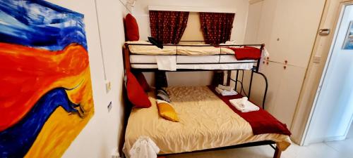 a room with two bunk beds and a painting at Astrofegia Apartments Near The Sea in Ayia Marina