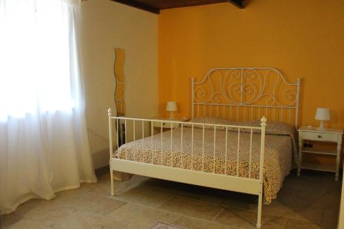 a bedroom with a white bed and a window at Masseria Marico in Castellaneta