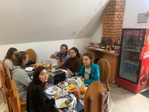 a group of people sitting at a table in a restaurant at David Crater Homestay in Lushoto