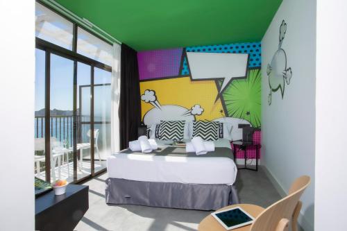 a bedroom with a bed and a balcony at Casual Pop Art Benidorm in Benidorm