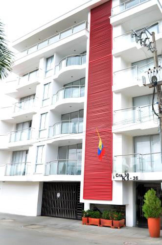 a building with a red and white facade at Hotel D' Leon Inn in Aguachica