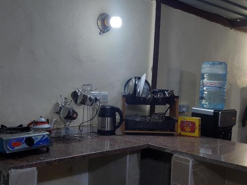 a kitchen with a counter top with appliances on it at Wadi Rum Oryx Hostel & Tours in Wadi Rum