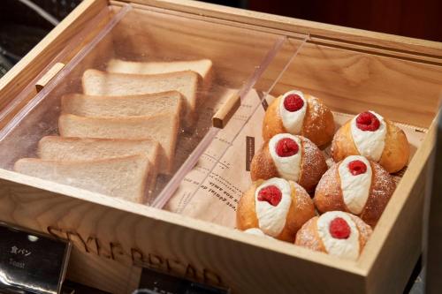 a box filled with pastries and breads in at Shibuya Tokyu REI Hotel in Tokyo