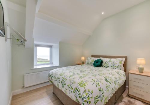 a bedroom with a bed with a teddy bear on it at Ty Mawr in Aberdaron