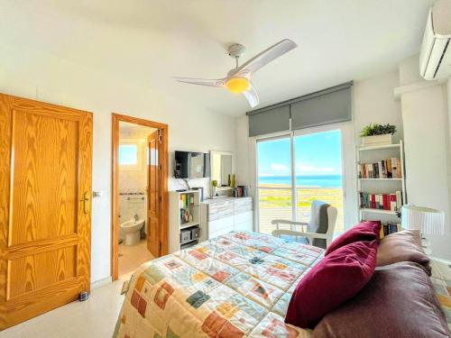 a bedroom with a bed and a view of the ocean at Bahia Blanca Arenales del Sol by Villas&You in Arenales del Sol