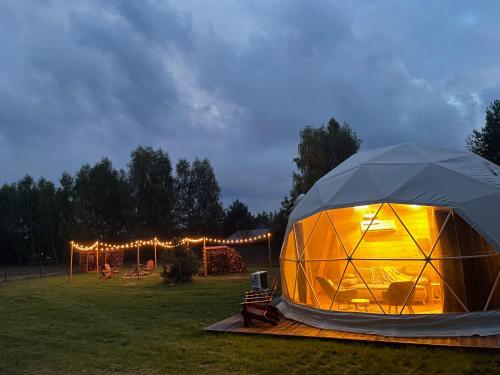 a tent in a field at night with lights at beGLAMP - Glamping nad Zalewem Próba in Brzeźnio
