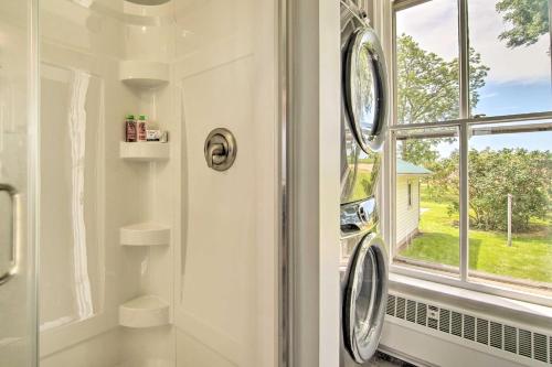 a bathroom with a shower and a window at Spacious Farmhouse on 200 Acres Along the River in Edgerton