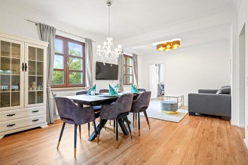 a dining room with a table and chairs at Schlossblick Tettnang in Tettnang