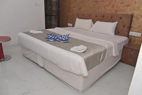 a large white bed with towels on top of it at Hotel Apni Haveli in Udaipur