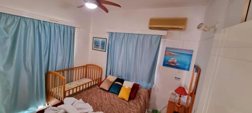 a small room with a crib in a room at Astrofegia Apartments Near The Sea in Ayia Marina