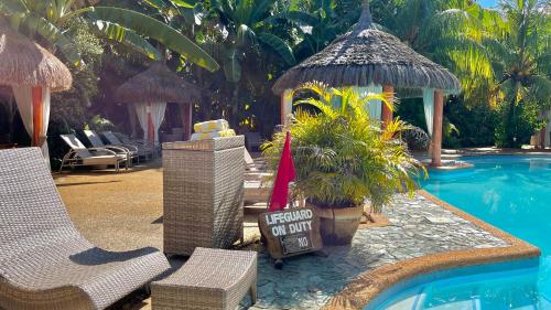 a resort with a swimming pool and a resort on top at Coco Grove Beach Resort, Siquijor Island in Siquijor
