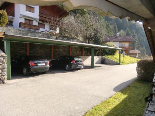 a garage with two cars parked in it at Ferienwohnungen Pfister in Zell am Ziller