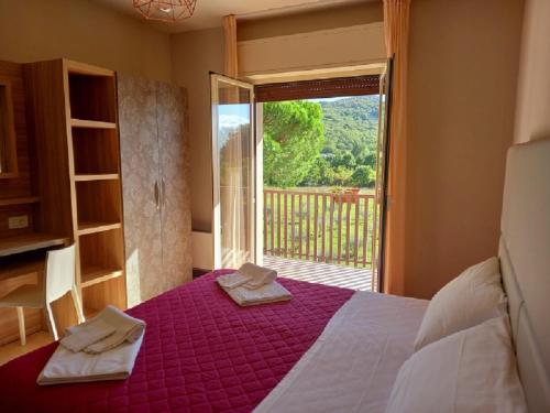 a bedroom with a bed and a window with a view at Hotel Torricella in Magione