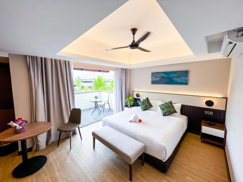a hotel room with a bed and a table at Villea Port Dickson in Port Dickson