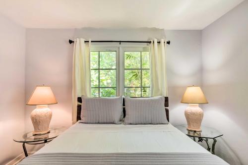 a bedroom with a large bed with two lamps at Vibrant West Palm Beach Home Less Than 2 Mi to Beach! in West Palm Beach