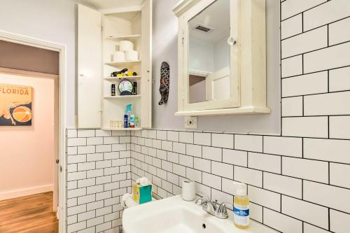 a white bathroom with a sink and a mirror at Vibrant West Palm Beach Home Less Than 2 Mi to Beach! in West Palm Beach