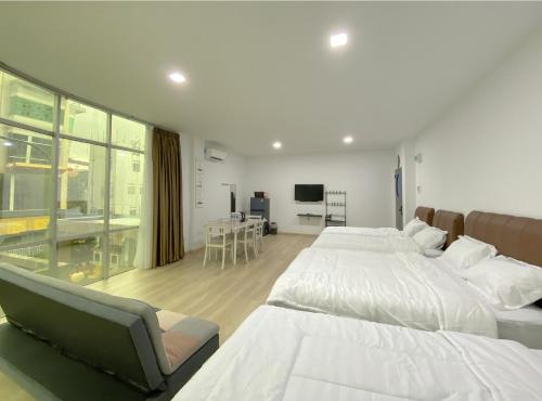 a bedroom with two beds and a living room at CN Homestay A2 Floor 1 at Nagoya Hill Mall in Nagoya
