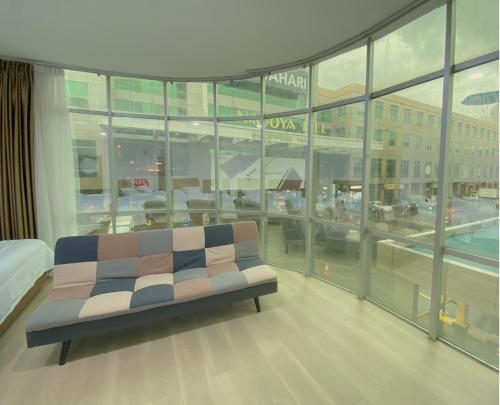 a room with a couch in front of a large window at CN Homestay A2 Floor 1 at Nagoya Hill Mall in Nagoya