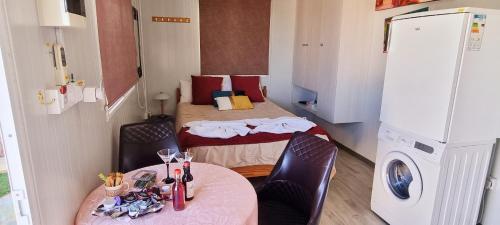 a small room with two beds and a refrigerator at Astrofegia Apartments Near The Sea in Ayia Marina