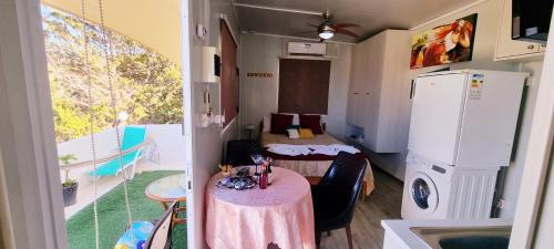 a small room with a table and a room with two beds at Astrofegia Apartments Near The Sea in Ayia Marina