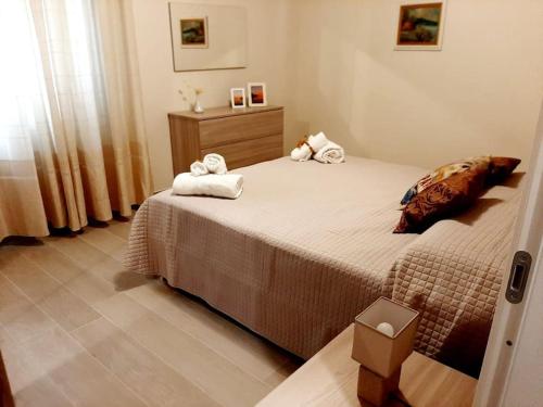 a bedroom with a bed with towels on it at Nichila - Casa Vacanze acitrezza in Acitrezza
