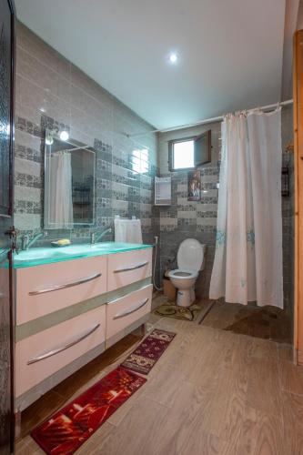 a bathroom with a sink and a toilet at Villa Kenza in Tahannout