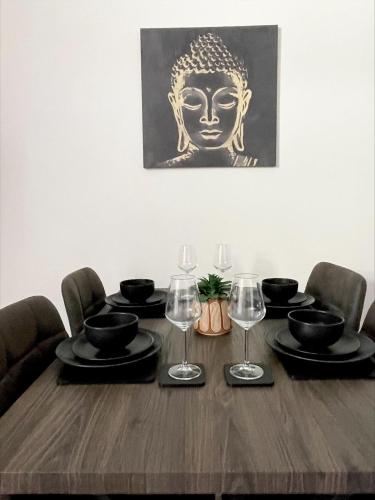 a dining room table with glasses and a head on the wall at Byelands House in Middlesbrough