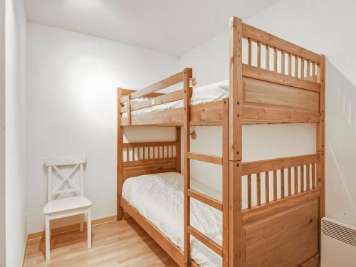 a bedroom with two bunk beds and a chair at Charmant T2 en Centre-Ville pour 6 pers., Parking, Proche Commodités et Stations de Ski - FR-1-402-75 in Luz-Saint-Sauveur