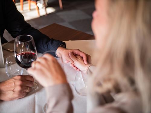 a group of people sitting at a table with wine glasses at Hotel Søgården Brørup in Brørup