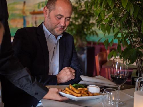 a man sitting at a table with a plate of food at Hotel Søgården Brørup in Brørup