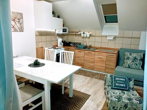 a kitchen and living room with a table and a couch at Apartmán Romanna in Terchová