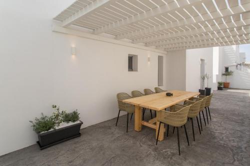 a dining room with a wooden table and chairs at Barbarigos luxury spa apartments in Naousa