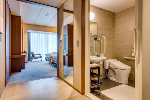 a bathroom with a toilet and a sink in a room at Hotel Okura Kyoto Okazaki Bettei in Kyoto