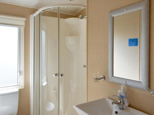 a bathroom with a shower and a sink and a mirror at The Pines - Uk11127 in Brough