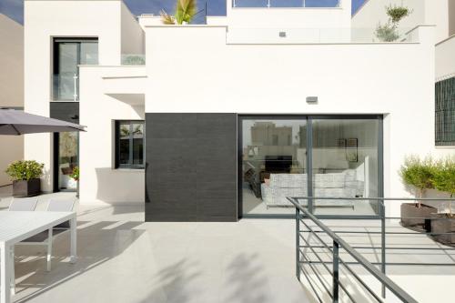 a view of a white house with a black facade at Villa Blanka, amazing villa with Hot tube & heated pool in Polop, Alicante in Polop