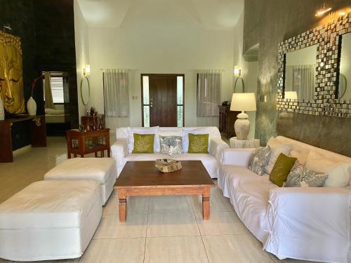 a living room with white couches and a coffee table at CASA BALI Juan Dolio Beach in Juan Dolio