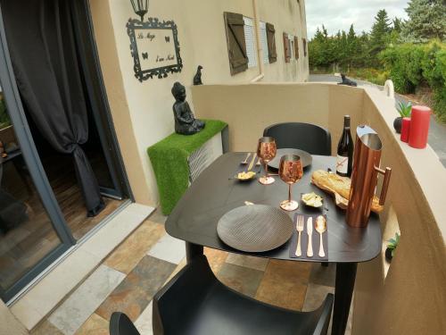 a small table and chairs on a balcony at La Magie d'une Nuit in Agde