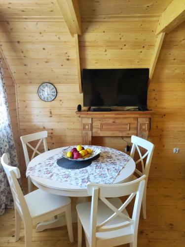 a dining room with a table with fruit on it at Good Time in Sasino