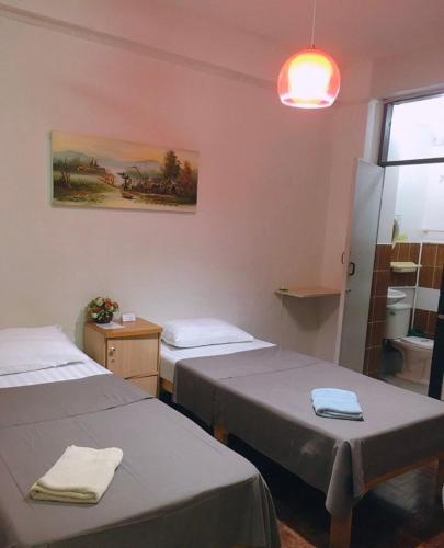 a hospital room with two beds and a window at Wayside Guesthouse in Chiang Mai