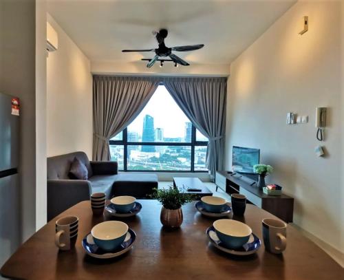 a living room with a table and a ceiling fan at SKS Pavillion 1Bedroom High Floor @2pax By HAUZ CINTA in Johor Bahru